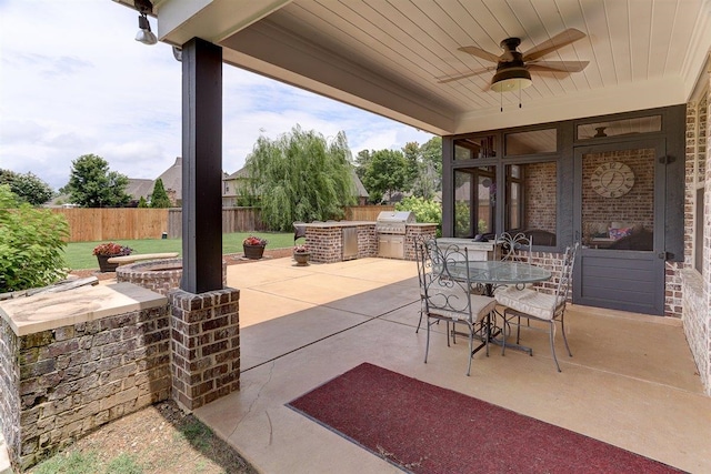 280 Cotton Trail Dr, Rossville, TN 38066 - fenced backyard with exterior kitchen, a patio area, a ceiling fan, and outdoor dining space