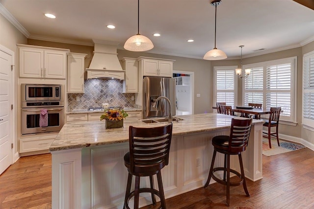 280 Cotton Trail Dr, Rossville, TN 38066 - kitchen featuring appliances with stainless steel finishes, custom range hood, decorative backsplash, ornamental molding, and light wood-style floors