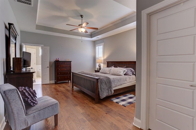 280 Cotton Trail Dr, Rossville, TN 38066 - bedroom featuring a tray ceiling, wood finished floors, ornamental molding, ceiling fan, and ensuite bathroom