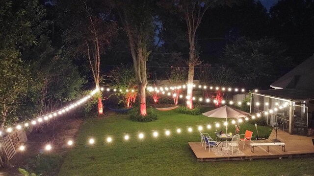 8429 King William St, Memphis, TN 38016 - yard at twilight with a wooden deck and a lawn