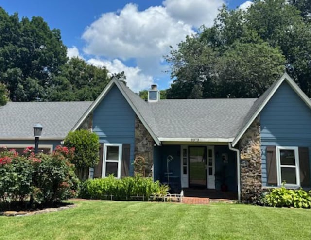9373 Glen Birnie Ln, Lakeland, TN 38002 - view of front of house featuring stone siding, a front lawn, a porch, and a chimney