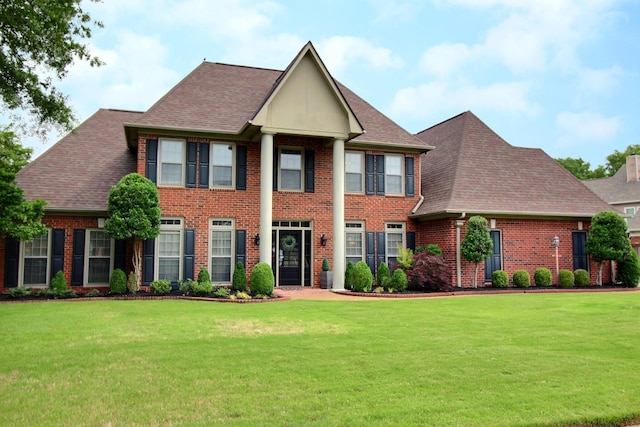 774 Wellington Way Cv, Collierville, TN 38017 - greek revival inspired property featuring brick siding, a front lawn, and roof with shingles