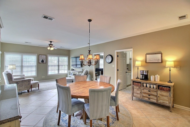 774 Wellington Way Cv, Collierville, TN 38017 - dining room featuring light tile patterned floors, a chandelier, a ceiling fan, and crown molding