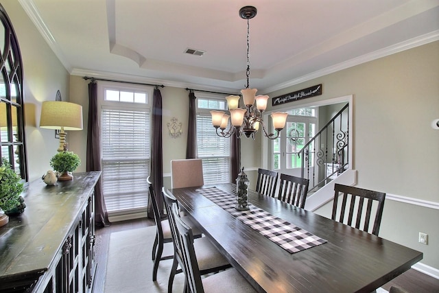 774 Wellington Way Cv, Collierville, TN 38017 - dining area with a chandelier, a tray ceiling, plenty of natural light, crown molding, and wood finished floors