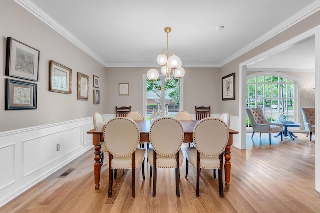2004 Kirby Rd, Memphis, TN 38119 - dining room featuring light wood finished floors, ornamental molding, a chandelier, wainscoting, and a decorative wall