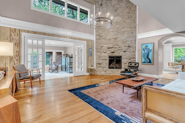 2004 Kirby Rd, Memphis, TN 38119 - living area featuring a high ceiling, french doors, wood finished floors, a chandelier, and a stone fireplace