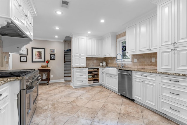 2004 Kirby Rd, Memphis, TN 38119 - kitchen with appliances with stainless steel finishes, crown molding, tasteful backsplash, white cabinetry, and recessed lighting