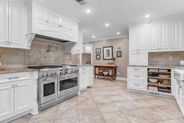 2004 Kirby Rd, Memphis, TN 38119 - kitchen with double oven range, ornamental molding, white cabinetry, tasteful backsplash, and recessed lighting