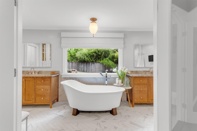 2004 Kirby Rd, Memphis, TN 38119 - bathroom featuring crown molding, two vanities, and a freestanding bath