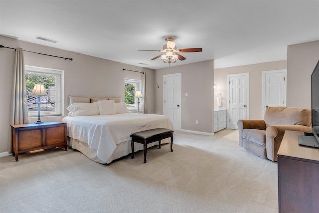 2004 Kirby Rd, Memphis, TN 38119 - bedroom featuring light colored carpet, multiple windows, ceiling fan, and ensuite bath