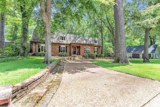 2004 Kirby Rd, Memphis, TN 38119 - view of front facade featuring brick siding, driveway, mansard roof, and a front lawn