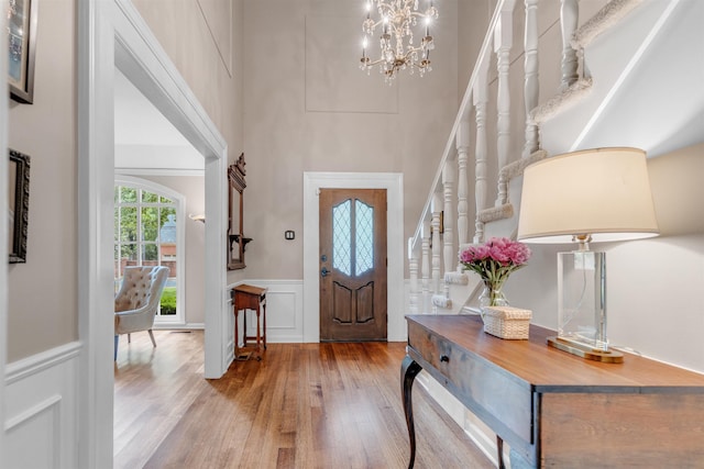 2004 Kirby Rd, Memphis, TN 38119 - foyer featuring wood finished floors, a towering ceiling, a wainscoted wall, a decorative wall, and a chandelier
