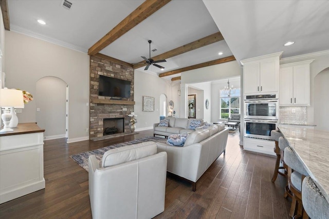 4741 Carousel Ln, Collierville, TN 38017 - living room featuring arched walkways, ceiling fan, a fireplace, dark wood-style flooring, and recessed lighting