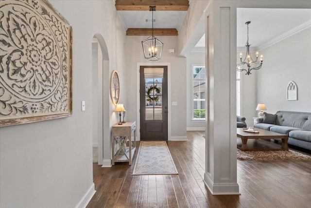 4741 Carousel Ln, Collierville, TN 38017 - entrance foyer with a chandelier, dark wood-style floors, arched walkways, and ornamental molding