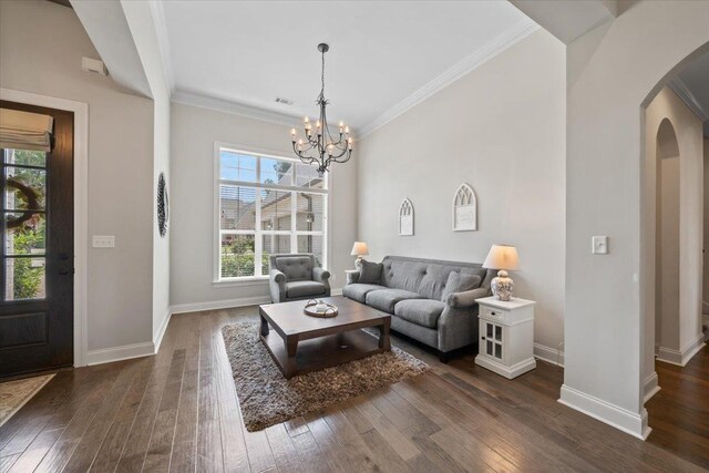 4741 Carousel Ln, Collierville, TN 38017 - living room with arched walkways, dark wood finished floors, a chandelier, and ornamental molding