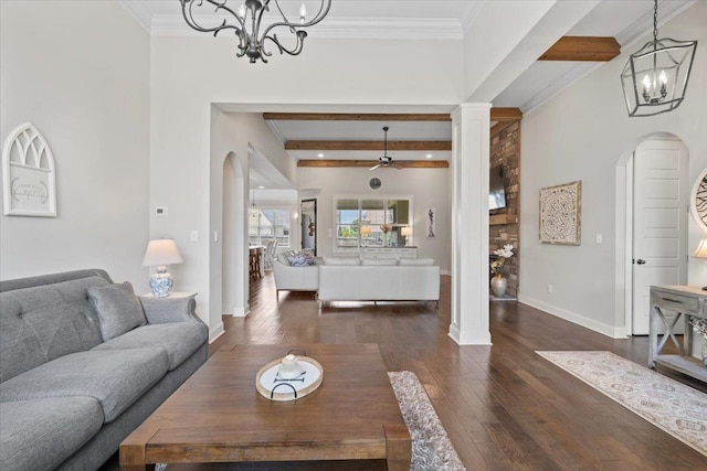 4741 Carousel Ln, Collierville, TN 38017 - living room featuring a chandelier, arched walkways, dark wood-style flooring, ornate columns, and ornamental molding