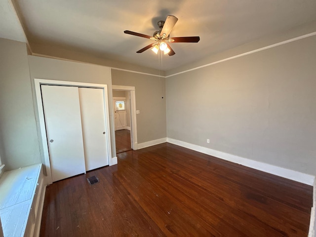 1053 Fleece Pl, Memphis, TN 38104 - unfurnished bedroom with dark wood finished floors, a closet, and ceiling fan