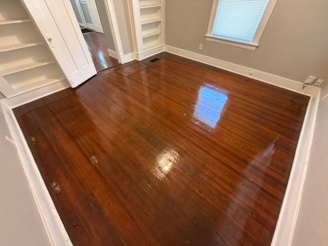 1053 Fleece Pl, Memphis, TN 38104 - unfurnished bedroom featuring dark wood-type flooring and baseboards