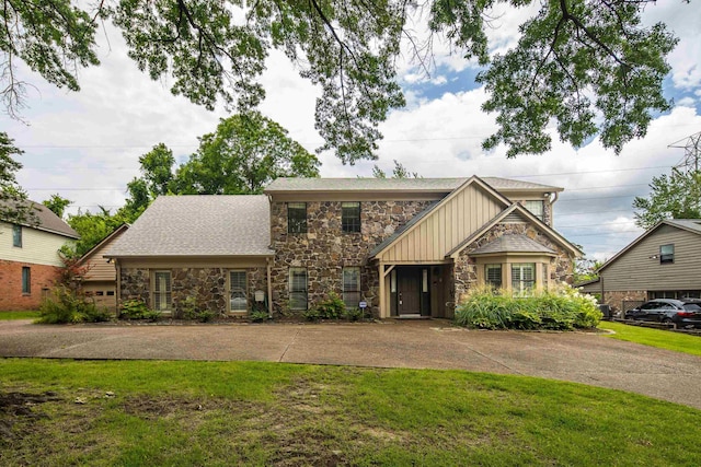 460 Jason Dr, Memphis, TN 38120 - view of front of house featuring stone siding, a front lawn, and board and batten siding