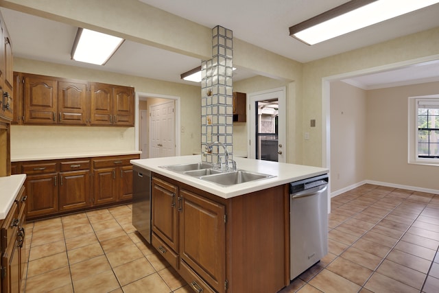 460 Jason Dr, Memphis, TN 38120 - kitchen featuring dishwasher, light countertops, a center island with sink, and light tile patterned floors