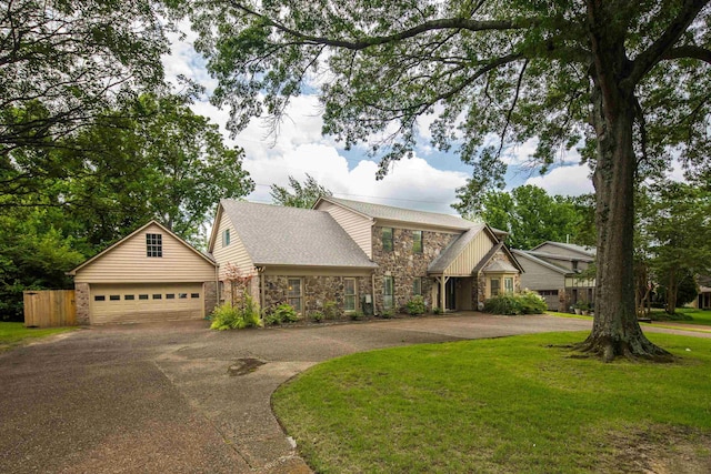 460 Jason Dr, Memphis, TN 38120 - view of front of property featuring asphalt driveway, stone siding, an outdoor structure, a front yard, and an attached garage