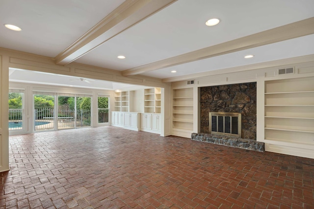 460 Jason Dr, Memphis, TN 38120 - unfurnished living room with beamed ceiling, built in shelves, a fireplace, brick floors, and recessed lighting