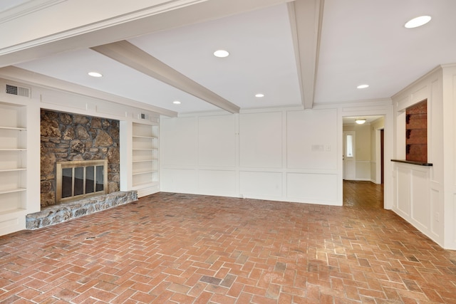 460 Jason Dr, Memphis, TN 38120 - unfurnished living room with a decorative wall, beamed ceiling, brick floors, a fireplace, and recessed lighting