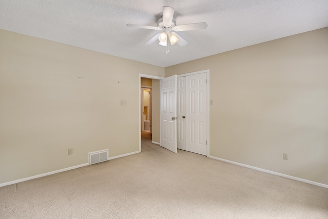 460 Jason Dr, Memphis, TN 38120 - unfurnished bedroom with light carpet, ceiling fan, a closet, and a textured ceiling