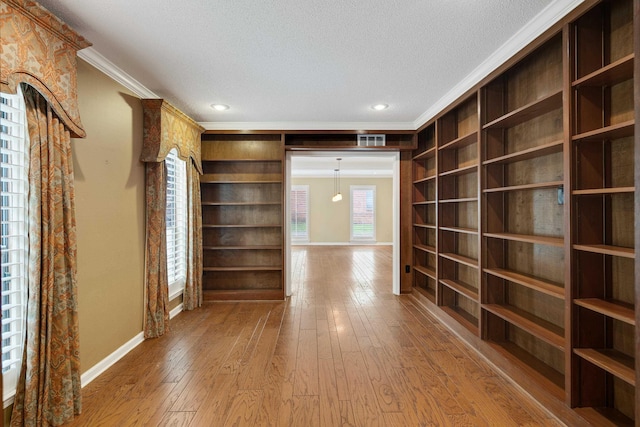 460 Jason Dr, Memphis, TN 38120 - corridor with crown molding, wood-type flooring, a textured ceiling, built in shelves, and recessed lighting
