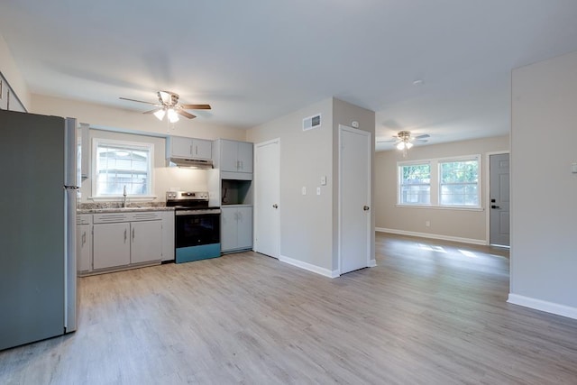 3292 Stella St, Memphis, TN 38127 - kitchen with stainless steel appliances, a ceiling fan, and light wood-style floors
