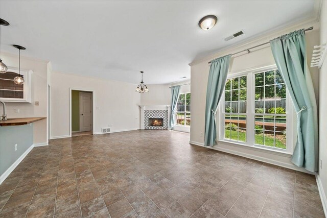 3760 Broadway Rd, Bartlett, TN 38135 - unfurnished living room featuring a tile fireplace and a chandelier