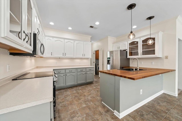 3760 Broadway Rd, Bartlett, TN 38135 - kitchen with stainless steel fridge, butcher block countertops, electric range oven, a peninsula, and ornamental molding