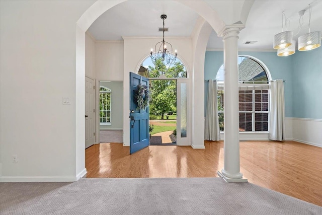 3760 Broadway Rd, Bartlett, TN 38135 - foyer entrance with ornate columns, arched walkways, ornamental molding, a chandelier, and wood finished floors