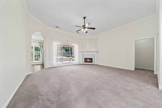 3760 Broadway Rd, Bartlett, TN 38135 - unfurnished living room featuring crown molding, ceiling fan, carpet, a fireplace, and arched walkways