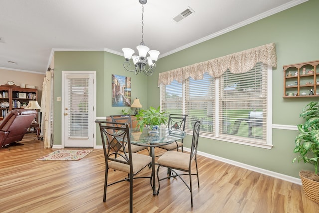 3964 Tonya Marie Ln, Bartlett, TN 38135 - dining room with wood finished floors, crown molding, and a chandelier
