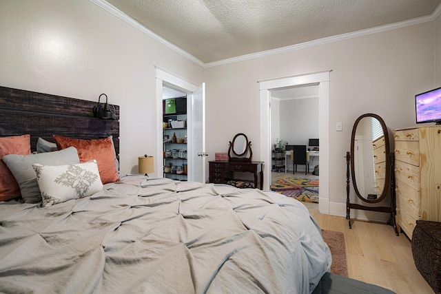 569 Lundee Pl, Memphis, TN 38111 - bedroom featuring light wood-type flooring, ornamental molding, and a textured ceiling