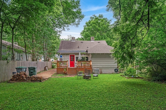 569 Lundee Pl, Memphis, TN 38111 - rear view of house with a wooden deck, a shingled roof, and a chimney