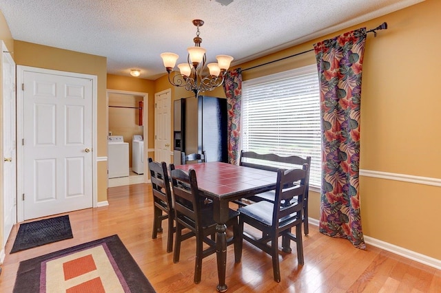 3365 Harrell Rd, Tn, TN 38002 - dining space with washer and dryer, a chandelier, light wood-style flooring, and a textured ceiling