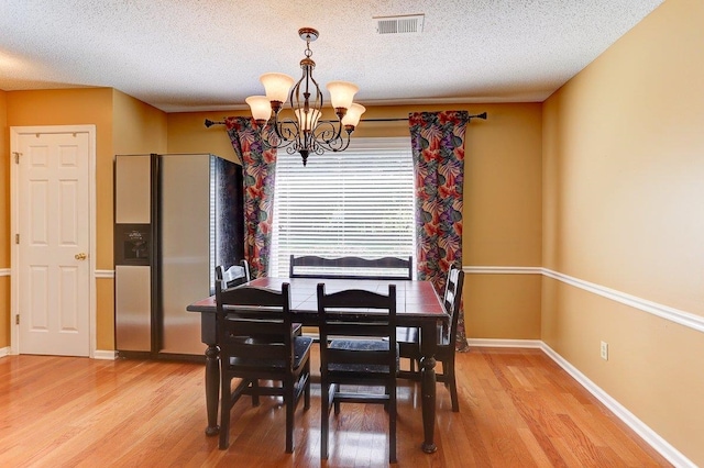 3365 Harrell Rd, Tn, TN 38002 - dining space featuring a chandelier, light wood finished floors, and a textured ceiling