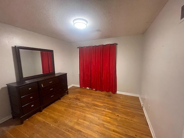 5128 Jessie Lee Ln, Memphis, TN 38118 - bedroom with wood finished floors and a textured ceiling