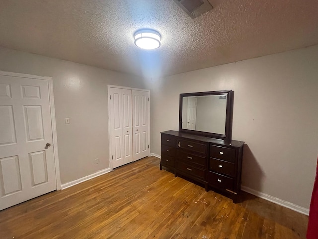 5128 Jessie Lee Ln, Memphis, TN 38118 - unfurnished bedroom featuring wood finished floors, a textured ceiling, and a closet