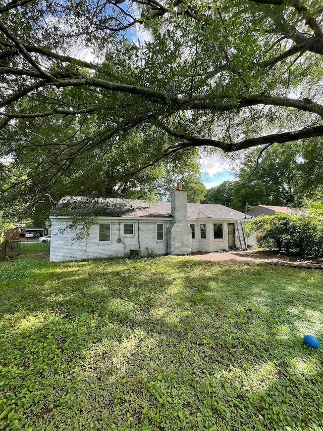 5128 Jessie Lee Ln, Memphis, TN 38118 - back of house featuring a chimney and a lawn