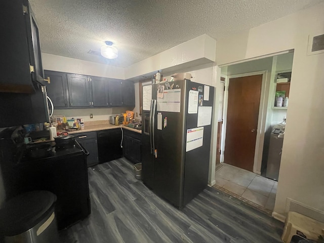 5128 Jessie Lee Ln, Memphis, TN 38118 - kitchen with stainless steel fridge, dark wood-style floors, a textured ceiling, light countertops, and dark cabinets