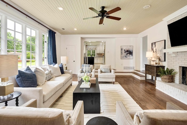 3846 Mimosa Ave, Memphis, TN 38111 - living room with a ceiling fan, wood finished floors, a fireplace, recessed lighting, and ornamental molding