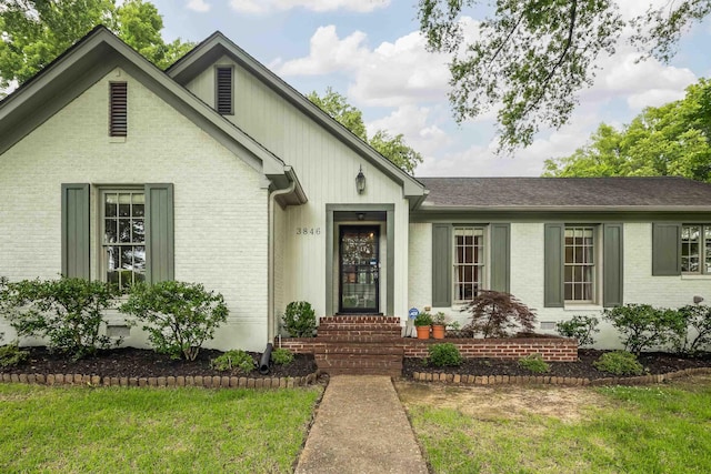 3846 Mimosa Ave, Memphis, TN 38111 - view of front facade with brick siding and a front lawn