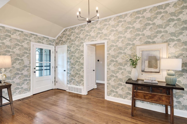 3846 Mimosa Ave, Memphis, TN 38111 - foyer entrance with ornamental molding, wood finished floors, a chandelier, vaulted ceiling, and wallpapered walls