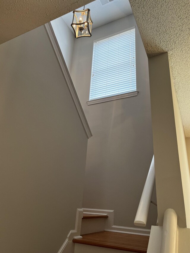 1182 Collierville-Arlington Rd, Collierville, TN 38017 - stairway with a chandelier and a textured ceiling