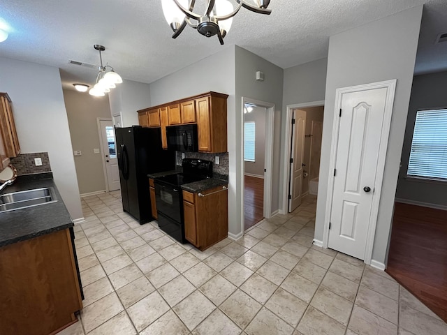 1182 Collierville-Arlington Rd, Collierville, TN 38017 - kitchen featuring black appliances, a chandelier, dark countertops, brown cabinets, and a textured ceiling