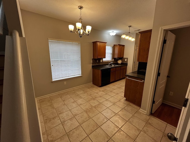 1182 Collierville-Arlington Rd, Collierville, TN 38017 - kitchen with dark countertops, black dishwasher, a chandelier, a textured ceiling, and pendant lighting