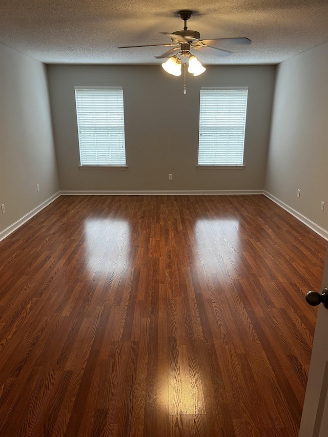 1182 Collierville-Arlington Rd, Collierville, TN 38017 - spare room with healthy amount of natural light, a ceiling fan, dark wood-style floors, and a textured ceiling